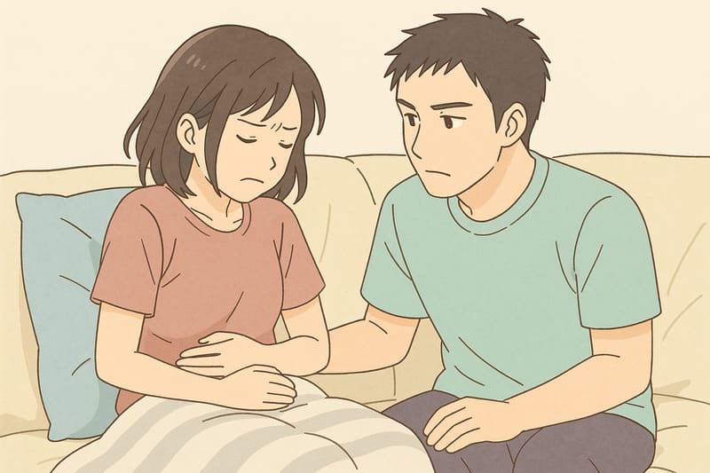 生理でお腹が痛い女性をいたわる男性