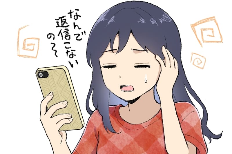 返信がこなくて頭を抱える女性